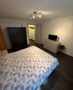a bedroom with a bed and a tv on a dresser at Casa Angelica in Quinto