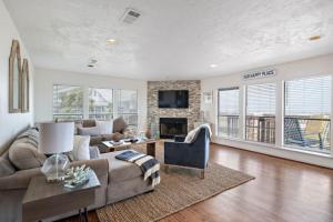 a living room with a couch and a fireplace at Secluded beachfront house with gorgeous ocean views in Galveston