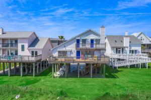 a row of houses with decks and grass at Secluded beachfront house with gorgeous ocean views in Galveston