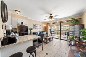 a kitchen and living room with a couch and a table at Casa Del Mar Unit 277 in Galveston
