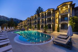 a hotel with a swimming pool in front of a building at Club Aquarium in Marmaris