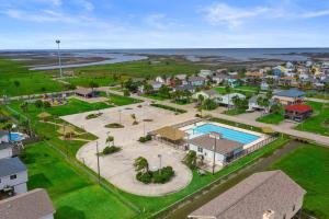 an aerial view of a resort with a swimming pool at Cozy beach bungalow close to ocean with large yard in Galveston