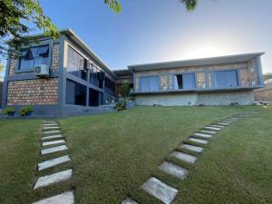 a house with a lawn in front of it at lodge3a in Ponta do Ouro