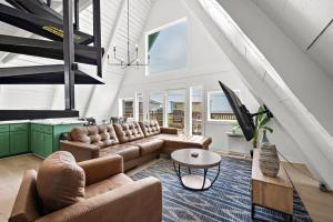 a living room with a couch and a table at Cozy A-frame with Fenced Yard, Fire Pit, Gulf View in Surfside Beach