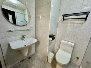 a bathroom with a sink and a toilet and a mirror at 竺韵旅宿 in Zhushan +9 photos