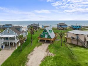 an aerial view of a group of houses and the ocean at Cozy A-frame with Fenced Yard, Fire Pit, Gulf View in Surfside Beach