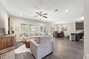 a living room with a couch and a ceiling fan at Beautiful home with lake views and in-ground pool in West Livingston