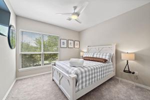 a bedroom with a bed and a window at Beautiful home with lake views and in-ground pool in West Livingston +55 photos