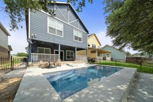 a house with a swimming pool in front of it at Beautiful home with lake views and in-ground pool in West Livingston