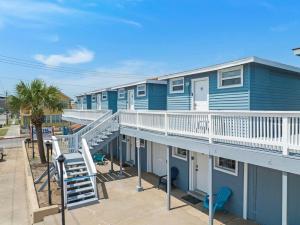 a row of blue condos with a balcony at Cozy ocean view condo on Galvestons east end, close to cruise terminal in Galveston
