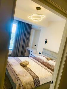 a bedroom with two beds and a large window at AIRPORT/PARKING/VINIETA.MD in Chişinău