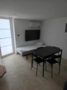 sala de estar con mesa negra y sillas en Canto Cigalo Duplex no 11, en Robion en Luberon