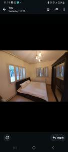 a bedroom with a bed and two windows at Weibdeh 3b furnished rooms in Amman +3 photos