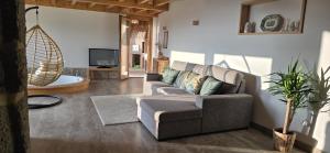 a living room with a couch and a tv at Casa Carballo in Puxedo