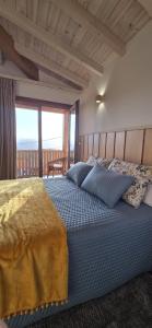 a bedroom with a large bed with a large window at Casa Carballo in Puxedo