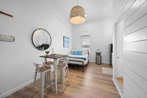 una stanza con un letto, un tavolo e delle sedie di Modern Downtown Galveston Loft, Walk to The Strand a Galveston