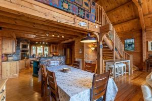 a kitchen and dining room with a table and chairs at Beary Relaxing Cabin in Banner Elk