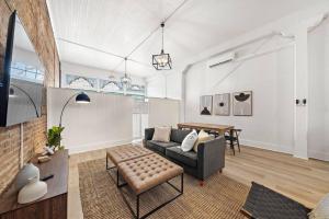 a living room with a couch and a table at Historic Downtown Galveston Flat With Game Room in Galveston