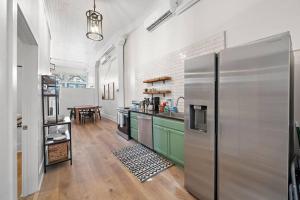 a kitchen with a stainless steel refrigerator in a room at Historic Downtown Galveston Flat With Game Room in Galveston
