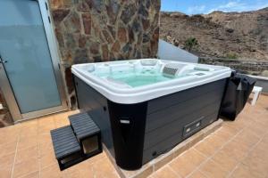 a large bath tub sitting on a patio at Villa Calma Tauro, Golf, Beach and Relax in La Playa de Tauro