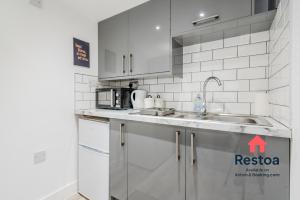 a kitchen with a sink and a counter top at Neepsend Lane Studios in Neepsend +19 photos