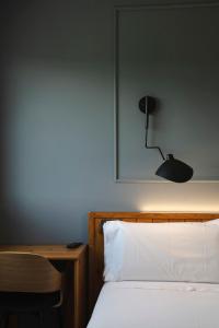 a bedroom with a bed with a lamp and a desk at El Ciervo in Villaciervos