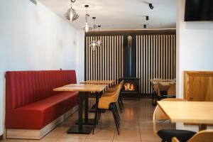 a restaurant with tables and chairs and a fireplace at El Ciervo in Villaciervos
