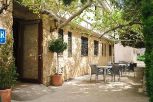 a table and chairs in front of a building at El Ciervo in Villaciervos