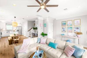 a living room with a white couch and a ceiling fan at Family Friendly 3-Bedroom Coastal Escape in Galveston