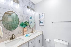 a bathroom with a sink and a mirror at Family Friendly 3-Bedroom Coastal Escape in Galveston +59 photos