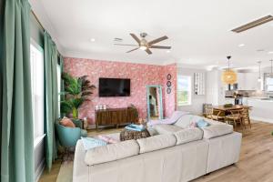 a living room with a white couch and a wall at Family Friendly 3-Bedroom Coastal Escape in Galveston