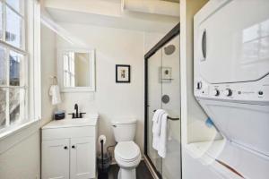 une salle de bain blanche avec toilettes et douche dans l'établissement Historic charmer close to all the beach and strand, à Galveston 67 autres photos