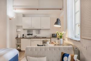 a kitchen and living room with a couch and a table at Studio Apartment 1 Min From Lake in Como