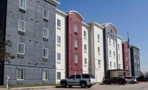 a white truck parked in front of a building at Candlewood Suites Houston I-10 East by IHG in Houston
