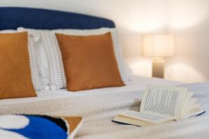a book sitting on top of a bed at Studio Apartment 1 Min From Lake in Como