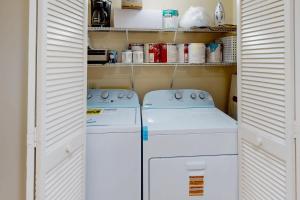 two washing machines in a small kitchen with white cabinets at Anchorage 7449 in Hilton Head Island +9 photos
