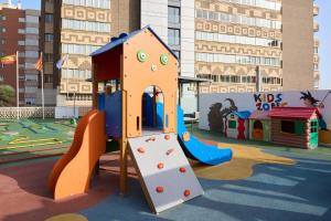 a playground with a slide and a play structure at Sercotel Maya Alicante in Alicante