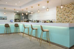 a bar in a restaurant with stools at Sercotel Maya Alicante in Alicante