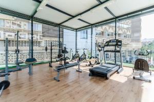 a gym with a lot of treadmills and machines at Sercotel Maya Alicante in Alicante