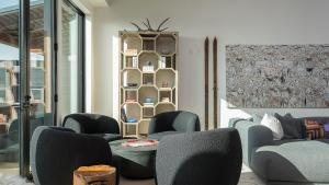 a room with chairs and a table and a shelf at Aria Ridge in Steamboat Springs