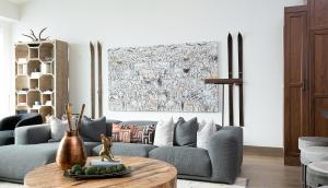 a living room with a blue couch and a table at Aria Ridge in Steamboat Springs