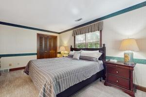 a bedroom with a large bed and a window at Trent Jones Cottage at Point O' Woods in Benton Harbor +102 photos