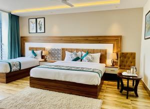 a hotel room with two beds and a chair at Hotel White Amritsar - A Luxury stay near golden temple in Amritsar
