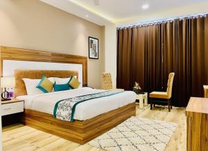 a bedroom with a bed and a desk and a chair at Hotel White Amritsar - A Luxury stay near golden temple in Amritsar