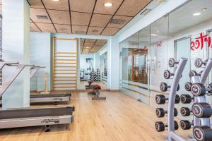 a gym with treadmills and machines in a room at Sercotel Las Artes Pinto in Pinto