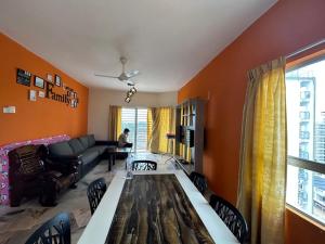 a living room with a table and a couch at ALR Homestay Mvv in Port Dickson
