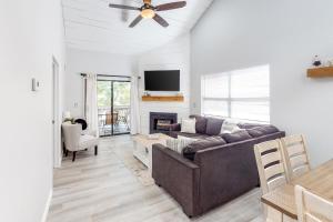 a living room with a couch and a fireplace at Pointe Royale Lofty Retreat at The Chic Chalet - Golf & Amenities Galore! in Branson