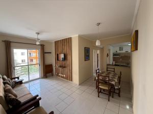 a living room with a couch and a table at Apartamento na Praia Grande Ubatuba in Ubatuba +24 photos