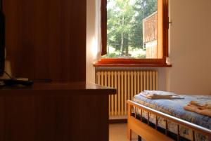 Postel nebo postele na pokoji v ubytování Albergo Legazzuolo Montecampione