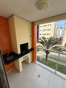 a bathroom with a sink and a large window at Apartamento na Praia Grande Ubatuba in Ubatuba